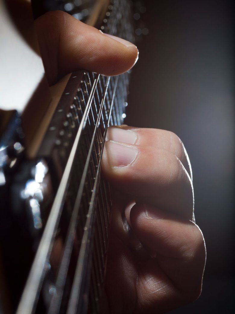 Close-up of a guitar being played at Rhythm Music Schools